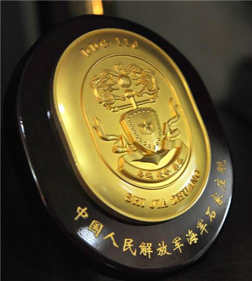 051C型导弹驱逐舰石家庄舰的舰徽。该舰是海军仅有的两艘&ldquo;俄式神盾&rdquo;驱逐舰之一，安装有全套的俄式SA-N-6&ldquo;雷鸣&rdquo;远程防空导弹系统。舰徽主体是代表中国文化的双龙戏珠图案和盾牌造型，凸显其防空&ldquo;神盾&rdquo;的定位。